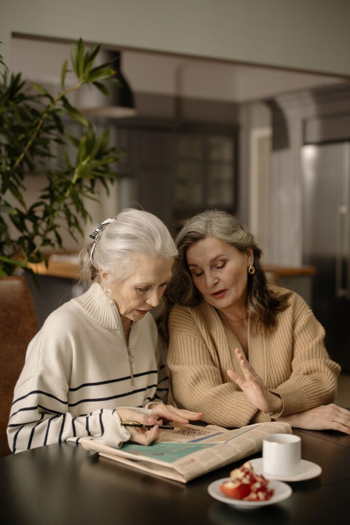 The 2-Hour Fall Problem: Why a Single Fall Can Change Everything — And How to Get Ahead of It sitting at dinner table with senior mom