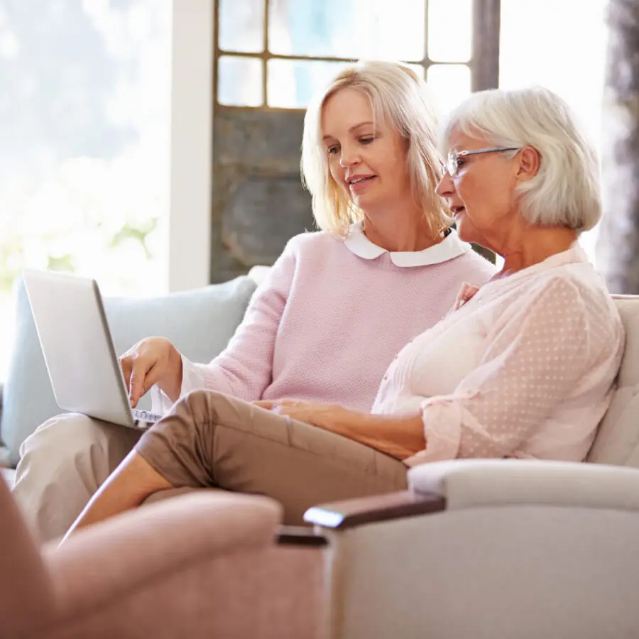 two seniors looks at a compter