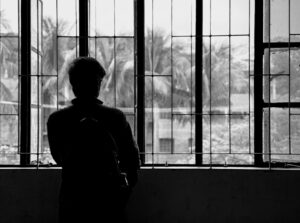 person looking out window, reflective